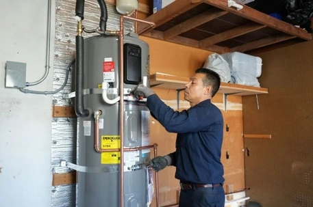 EVR Plumbing technician installing energy-efficient heat pump water system