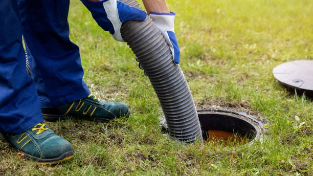 Septic tank maintenance in Queensland by EVR Plumbing with a technician servicing an underground wastewater system