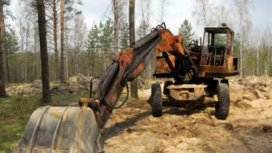 Acreage earthmoving and site clearing with excavator preparing ground for excavation works