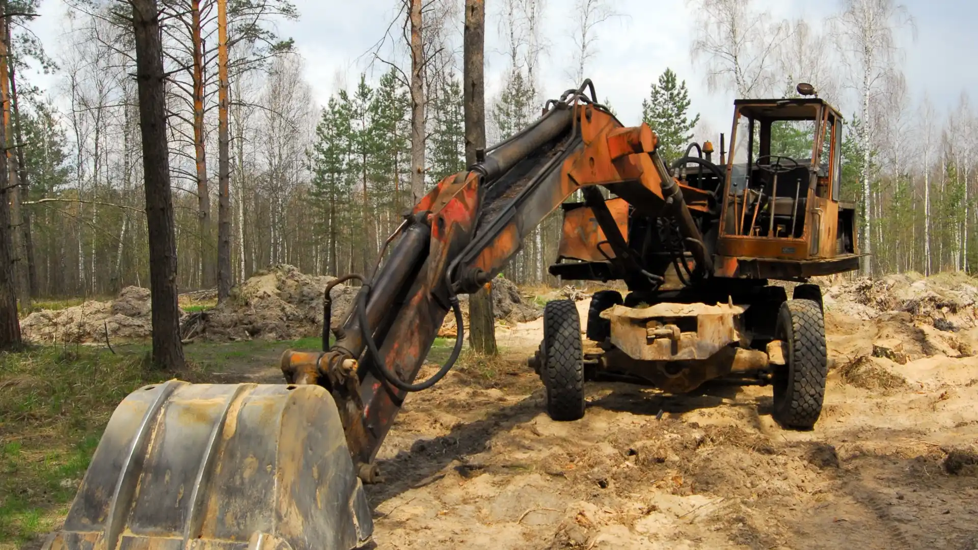 Acreage earthmoving and site clearing with excavator preparing ground for excavation works